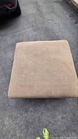 Top view of square grey-brown fabric ottoman