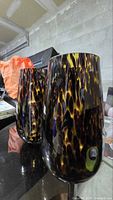 Two tortoiseshell glass lamps side view showing pattern and shape