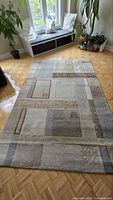Full view of rectangular patchwork shag rug on parquet floor