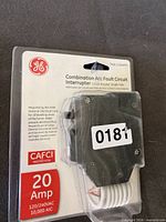 Front view of first sealed GE 20 A CAFCI breaker package