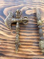 Combination vajra axe with spike showing brass material and ornamentation