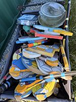 Cart containing cartoon-style wooden wickets stacked on mallets and accessories