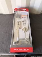 Boxed Kwikset front door lock set showing full package