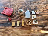 Group shot of all lighters and pouch on wooden surface