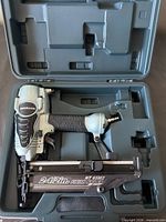 Nailer in fitted case showing full tool and magazine