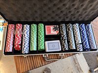 Open aluminum case showing chips, cards and dealer button