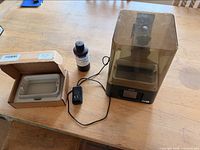 Printer with cover, power adapter, boxed resin vat and resin bottle