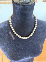 Full view of necklace on bust showing bead uniformity