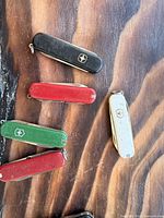 Assorted Swiss Army knives grouped on tabletop