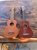 Front view of both ukuleles side by side