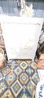 Full view of white crib side panel with animal motif