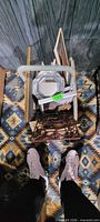 Top view of basket showing octagonal mirror, assorted frames, metal easel