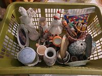 Overview of basket with assorted porcelain, metal, LEGO and doll