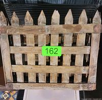 Front view of one wooden slat basket with picket top