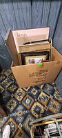 Box filled with assorted framed prints and frames