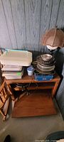 Overall lot showing bakeware stack, plastic carriers, tray, blue appliance