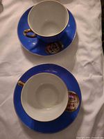 Two cobalt blue cups and saucers displayed top view