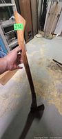 Full view of wood-handled axe showing handle grain and steel head