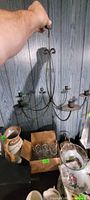 Chandelier held upright showing overall shape and candle holders