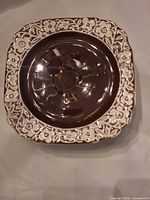 Top view of a single plate showing brown center and floral border