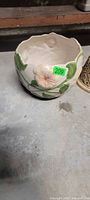 ceramic planter with relief floral motif and scalloped rim