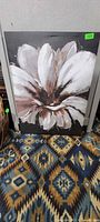 Full view of the flower canvas art leaning against wall