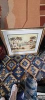 Full view of framed print on patterned rug