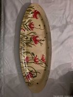 Full view of elongated oval glass tray with poppy decoration