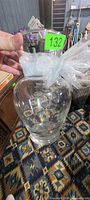 Entire clear glass vase showing shape and ribbon