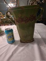 Full view of vase next to soda can for scale
