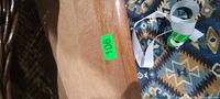close view of tabletop showing wood grain, finish wear, lot sticker