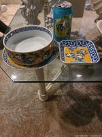 Bowl and square dish alongside soda can for scale