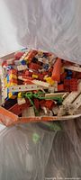 Open plastic bag showing mixed Lego pieces