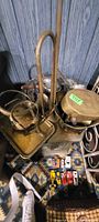 Lot overview showing brass bugles inside coal scuttle and silver tray behind