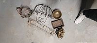Group of six assorted metal items on floor