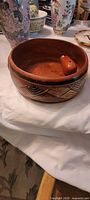 Shallow bowl with decorative band and small loose pottery piece