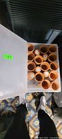 Top view showing quantity and arrangement of terracotta pots in bin