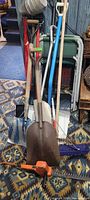 Group view of chairs, shovels, broom, string trimmer