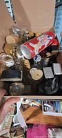 Box containing assorted empty perfume bottles