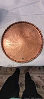 Top view showing full engraved design and scalloped rim