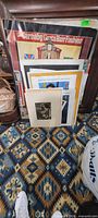 Stack of posters with framed Carnaby Gets Hair Fashion poster at front
