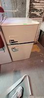 Cream Insignia retro mini fridge exterior with two chrome-handled doors