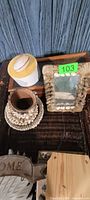 Group view: frame, shell-covered holder, coaster, white container with shell lid