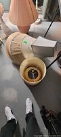 Group of assorted lamp shades stacked on floor