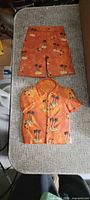 Both plaster plaques, shirt above shorts showing full design