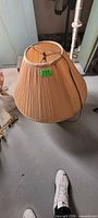 Pleated beige fabric shade with harp visible