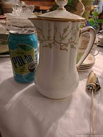Full teapot next to soda can for scale, shows overall shape and pattern