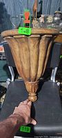 Front view of carved wooden wall shelf on chair