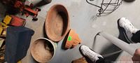 Group of planters on floor showing semi-circular terra cotta piece and others