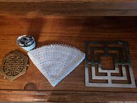 Overview of three trivets on wooden surface